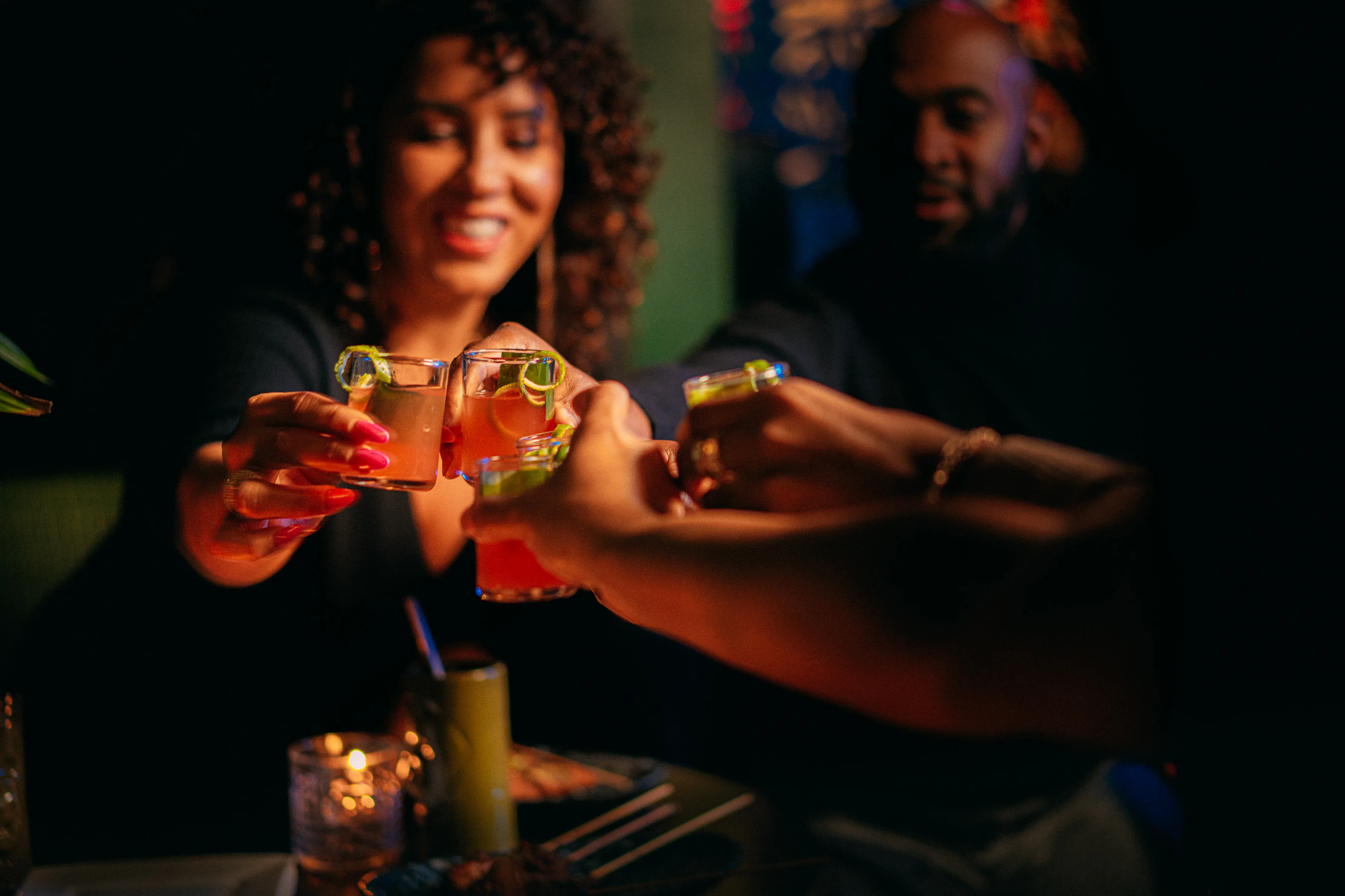 Guests raising cocktails together at Sobre Mesa