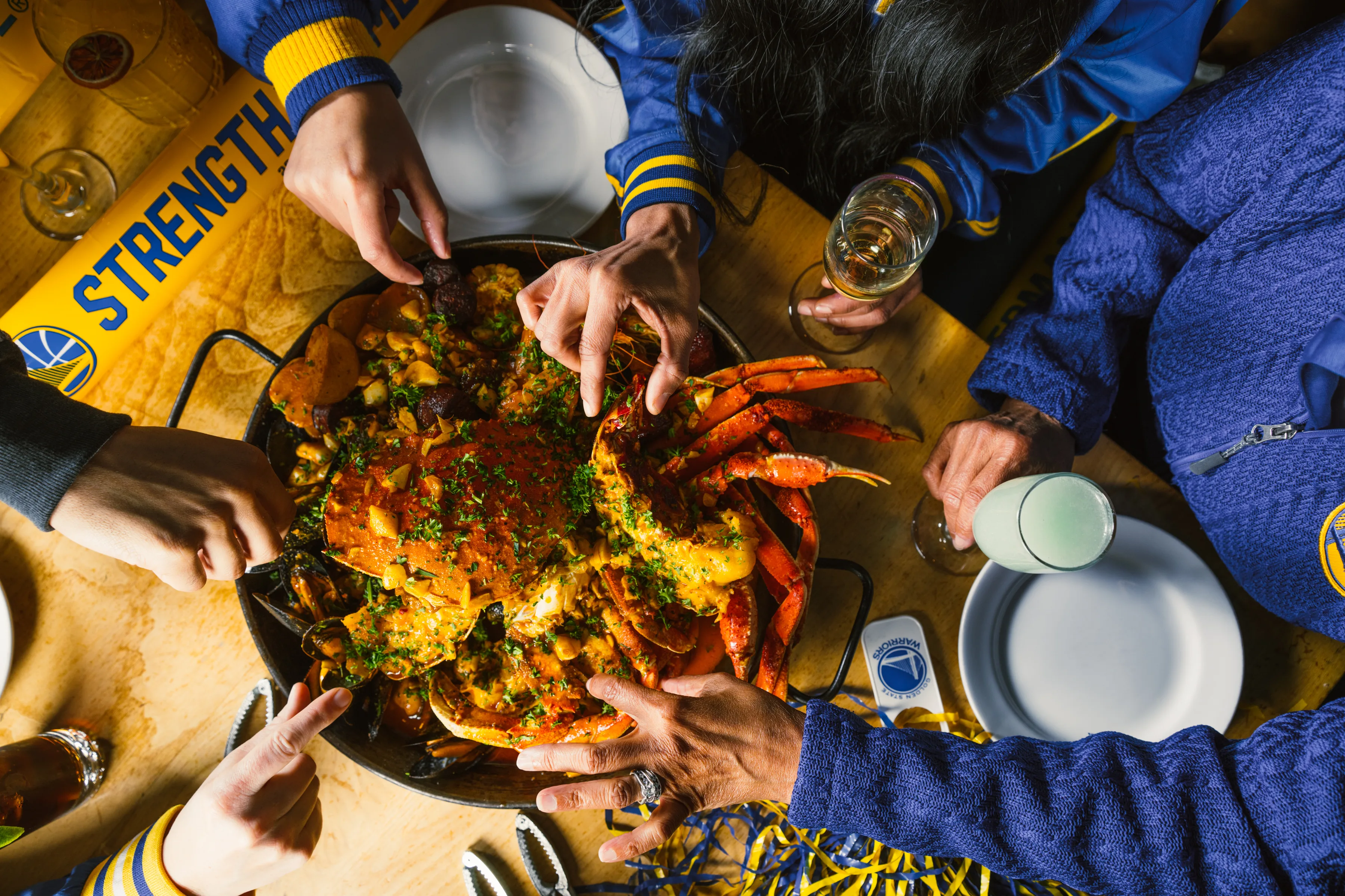 Guests sharing a seafood feast at alaMar