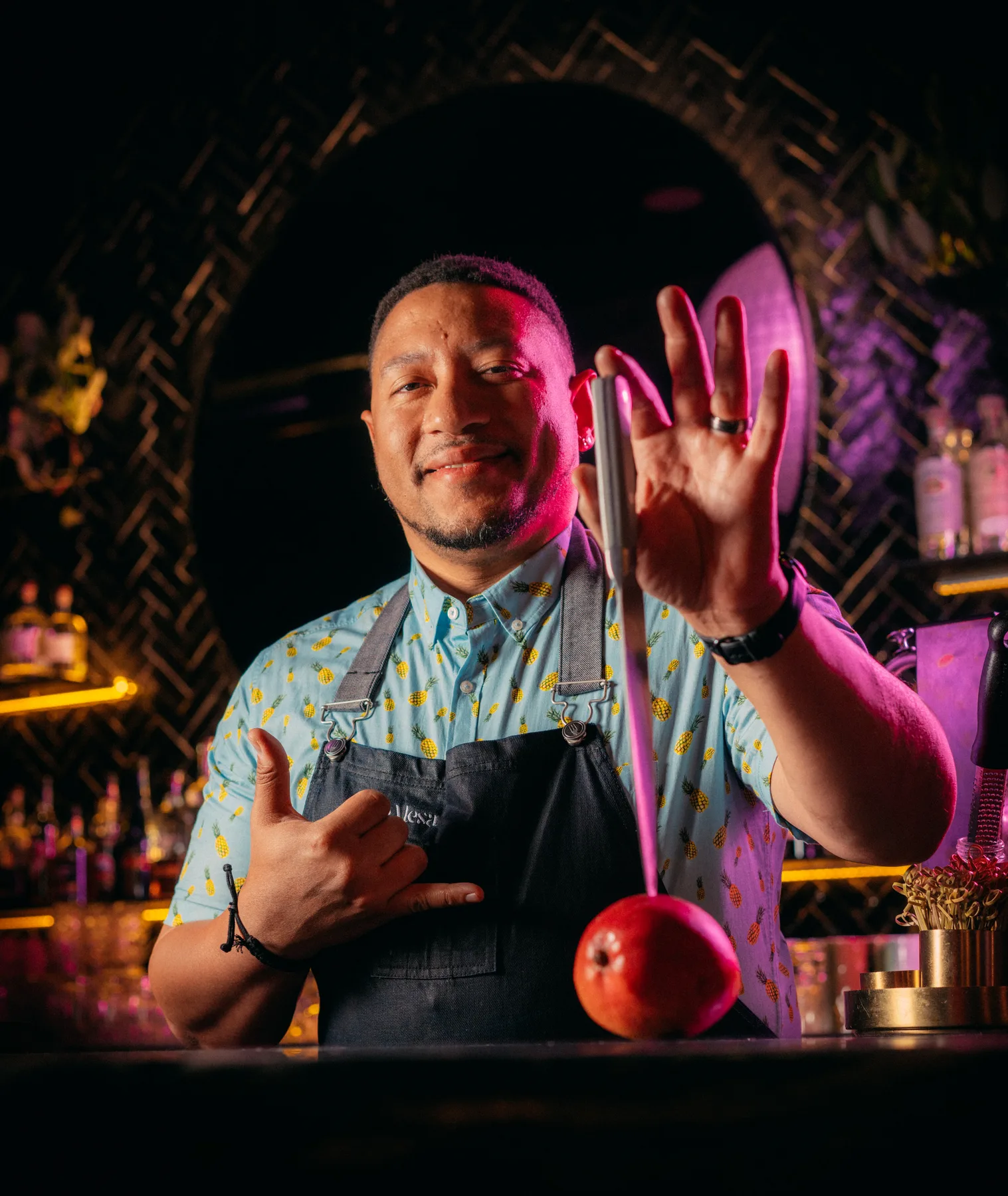 Chef Nelson German mixing a cocktail behind the bar at Sobre Mesa